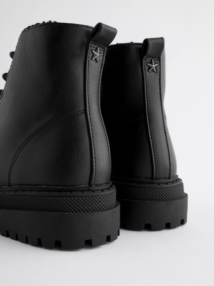 Matte black ankle boots with warm lining and lacing.