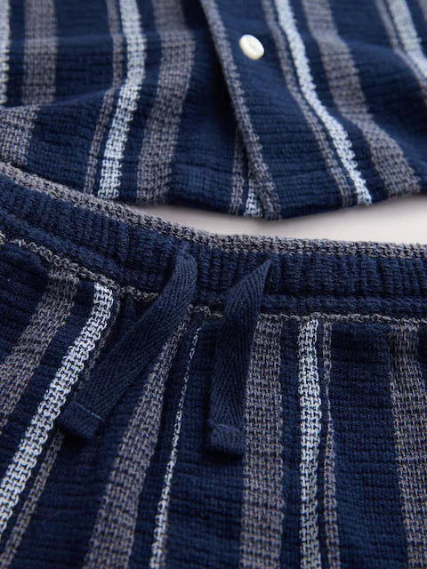Navy blue/white set consisting of a short-sleeved shirt and shorts with textured stripes