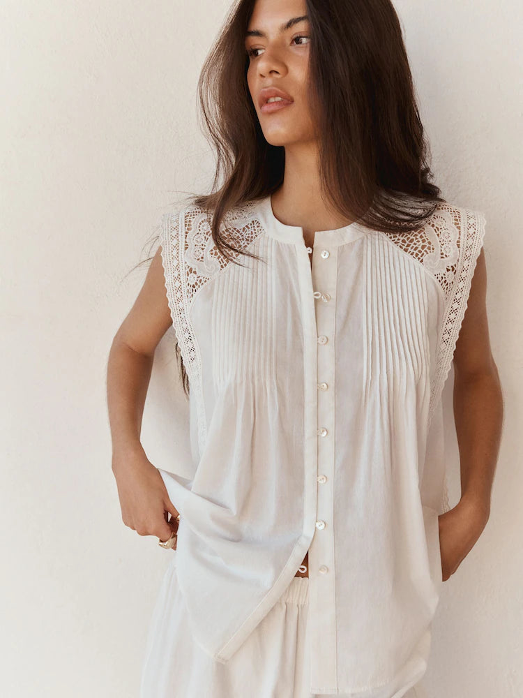 Romantic sleeveless blouse with eyelet lace.
