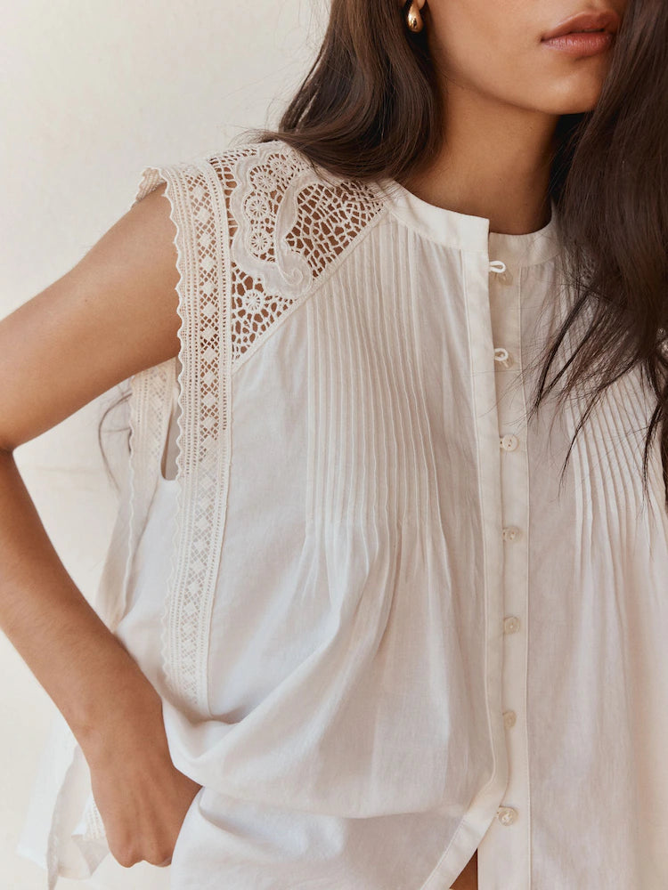 Romantic sleeveless blouse with eyelet lace.