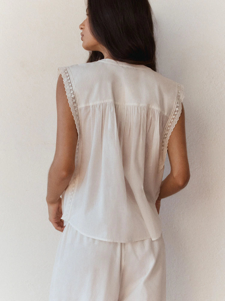Romantic sleeveless blouse with eyelet lace.