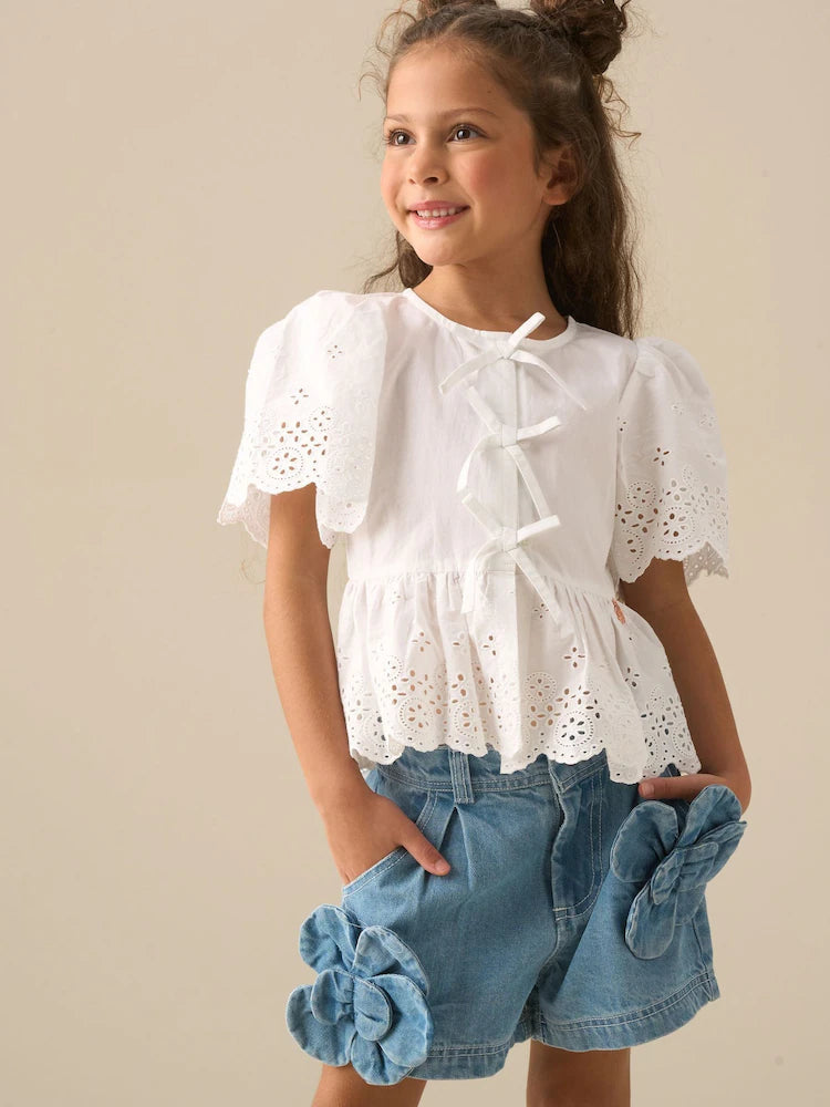 White - Angel & Rocket Ria blouse with eyelet embroidery, tie front and peplum