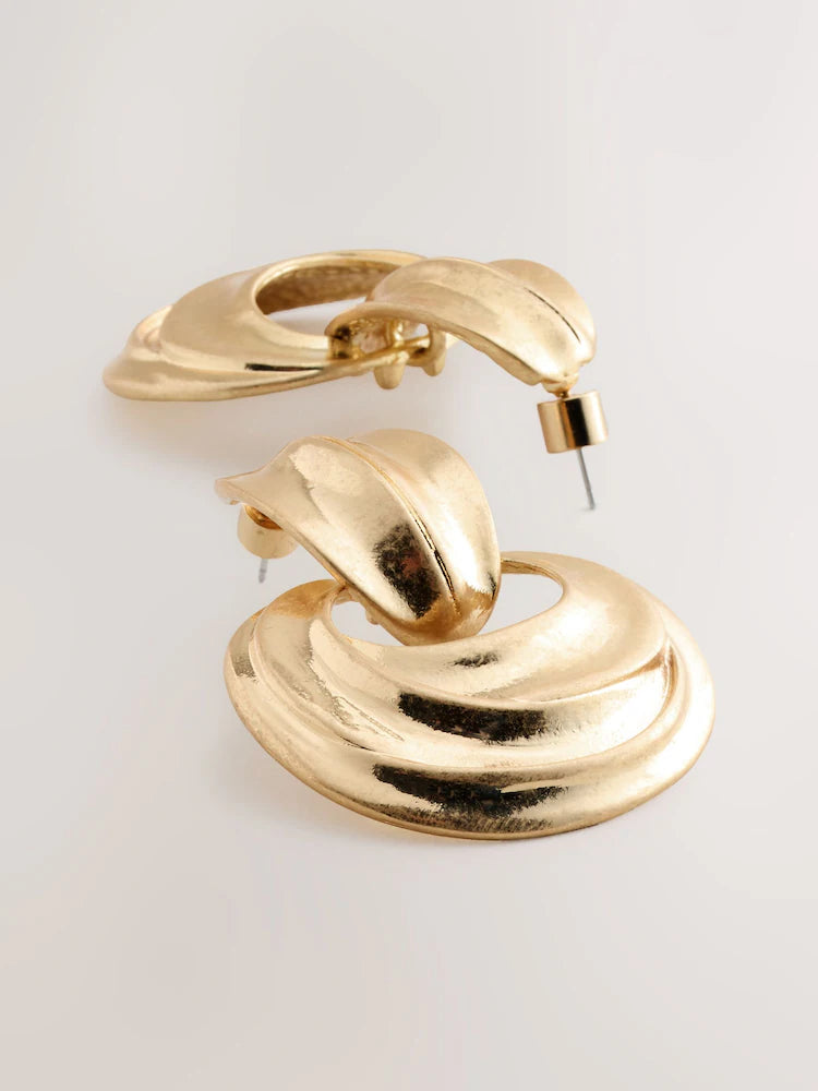 Gold-colored statement hoop earrings with pendants