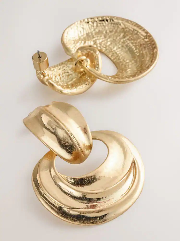 Gold-colored statement hoop earrings with pendants